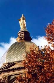 The stunning gold leaf of the Golden Dome and Our Lady of the Lake above the Administration Building of Notre Dame du lac.