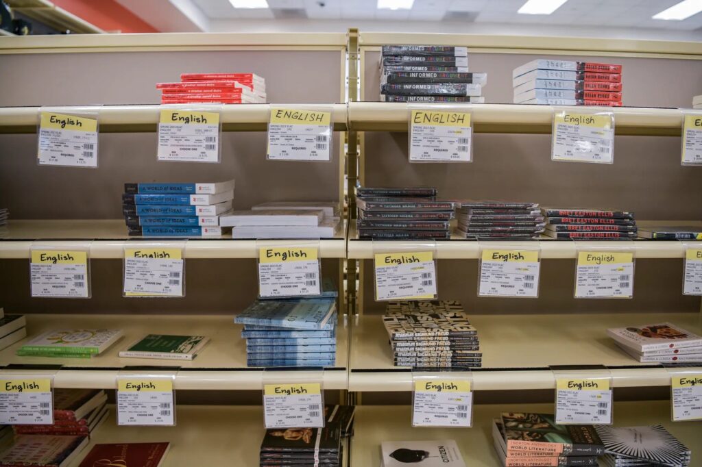 Academic books stacked with class information at the book store.