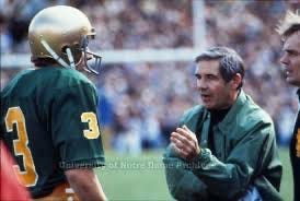 Photograph of Joe Montana (#3) talking to Coach Dan Devine during a football game.  Biography of Dr. Anthony J. Carbone.