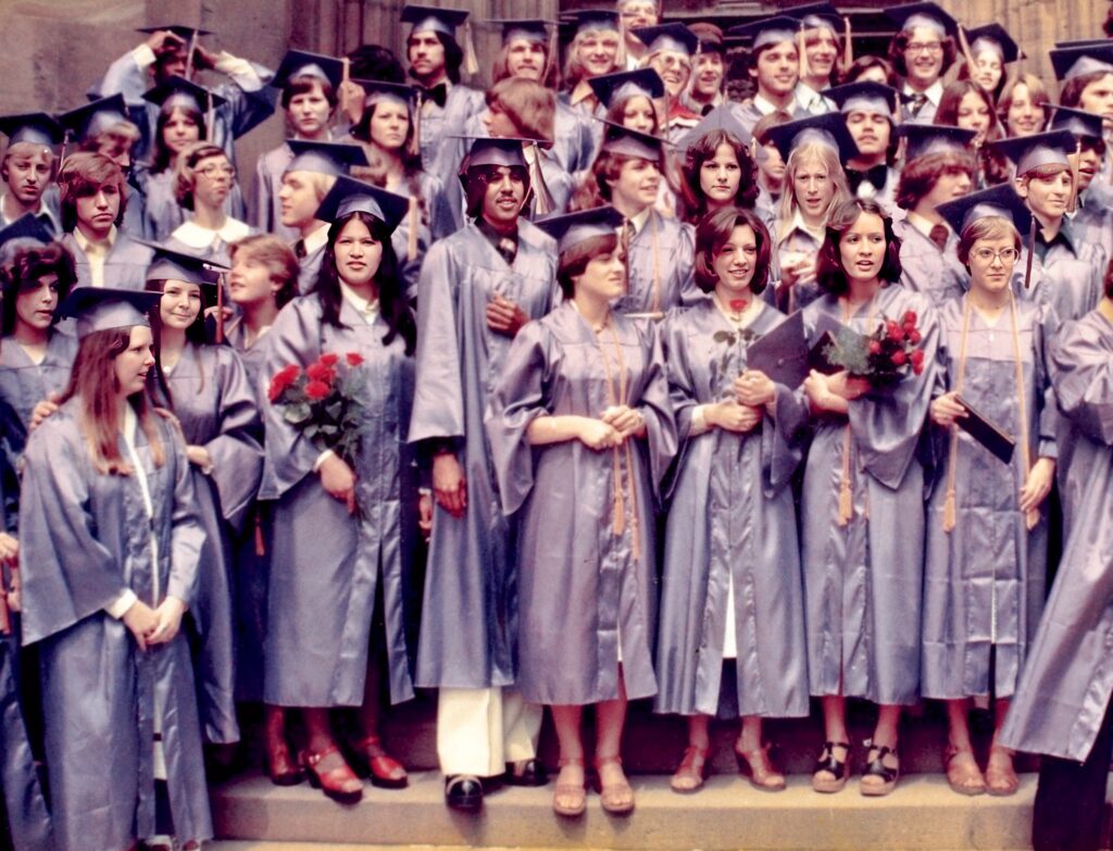 Graduating Class of 1977 in cap & gown, Mannheim American High School, Mannheim, Germany.  Biography of Dr. Anthony J. Carbone.