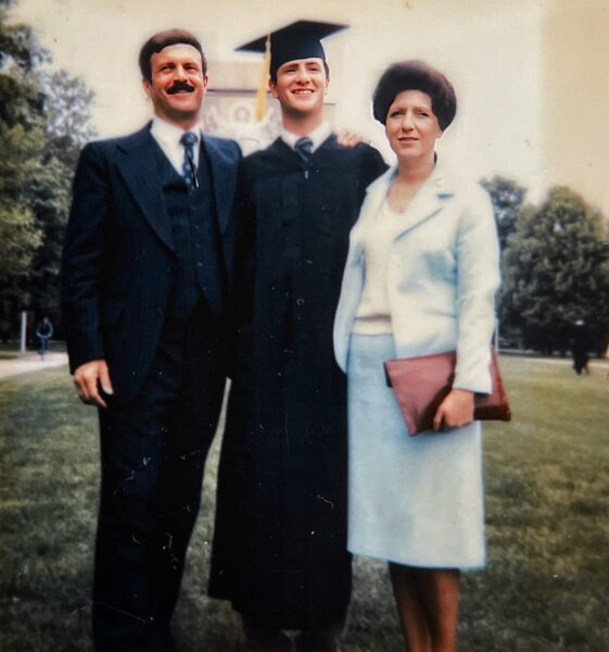 Photo of graduate Anthony J. Carbone with his parents Colonel Tony and Edda Carbone. In front of the Hesburg Library at the University of Notre Dame.