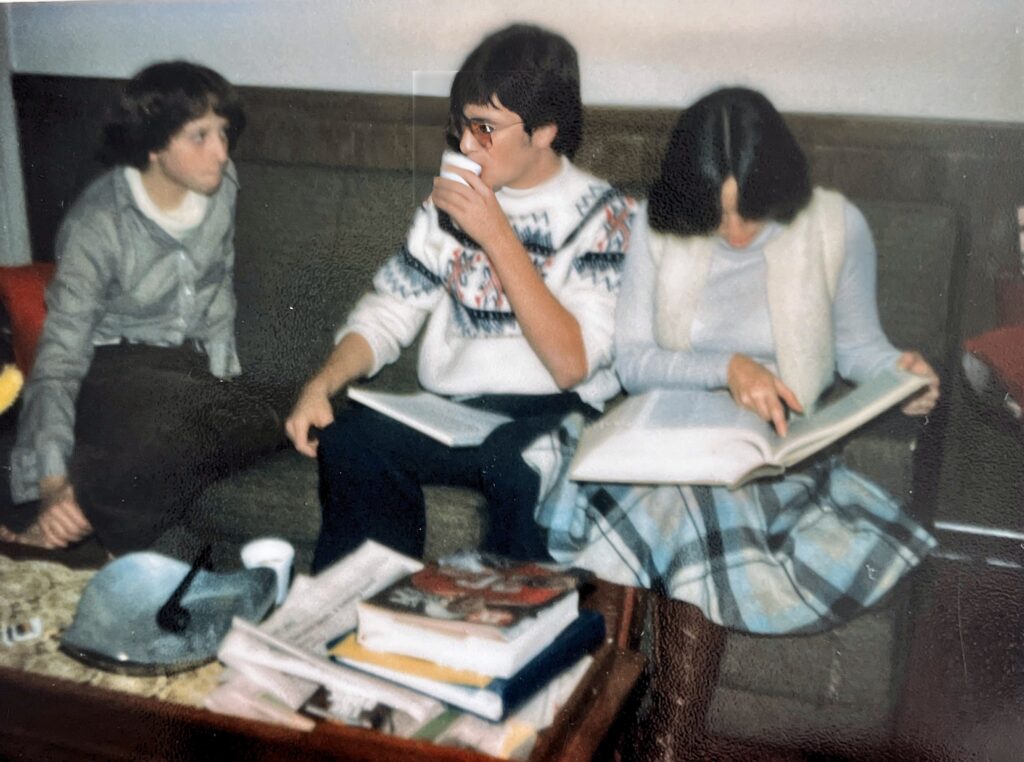 Photograph of 3 people sitting on a couch, one young man and two young ladies.  Biography of Dr. Anthony J. Carbone.