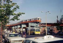 Photograph of elevated trolley in Boston with buses and taxi cabs waiting circa 1979.  Autobiography of Dr. Anthony J. Carbone.