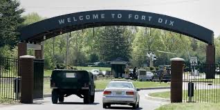 Photograph of Main Gate to Fort Dix, New Jersey with "Welcome to Fort Dix" sign on arch.  HUMVEE driving through gate.  Biography of Dr. Anthony J. Carbone.