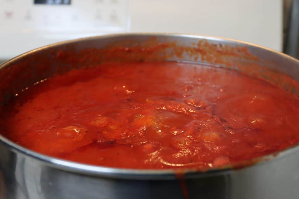Photograph of large pot of tomato sauce.  Autobiography of Dr. Anthony J. Carbone.