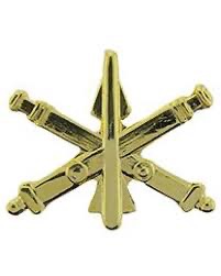 U.S. Army gold Air Defense Artillery branch insignia with crossed cannons and rocket in center.  Biography of Dr. Anthony J. Carbone.