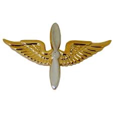 U.S. Army Aviation Officer branch insignia with gold wings and silver propeller in center.  Biography of Dr. Anthony J. Carbone.