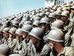 Group of Army cadets in olive drab fatigues with steel pot helmets.  Biography of Dr. Anthony J. Carbone.