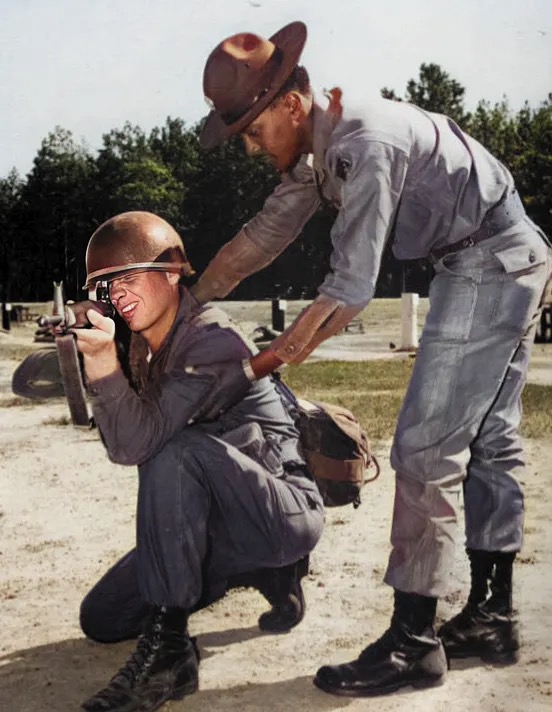 Soldiers in fatigues circa 1970s firing M16A1 rifles on a firing range.  Biography of Dr. Anthony J. Carbone.