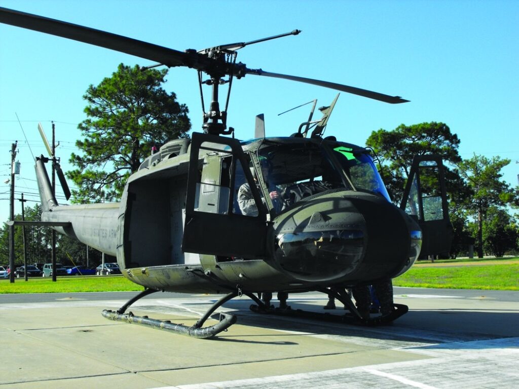 U.S. Army UH-1 Huey helicopter.  Biography of Dr. Anthony J. Carbone.