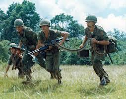 4 members of Infantry fire team with M60 machine gun and belt of rounds.  Biography of Dr. Anthony J. Carbone.