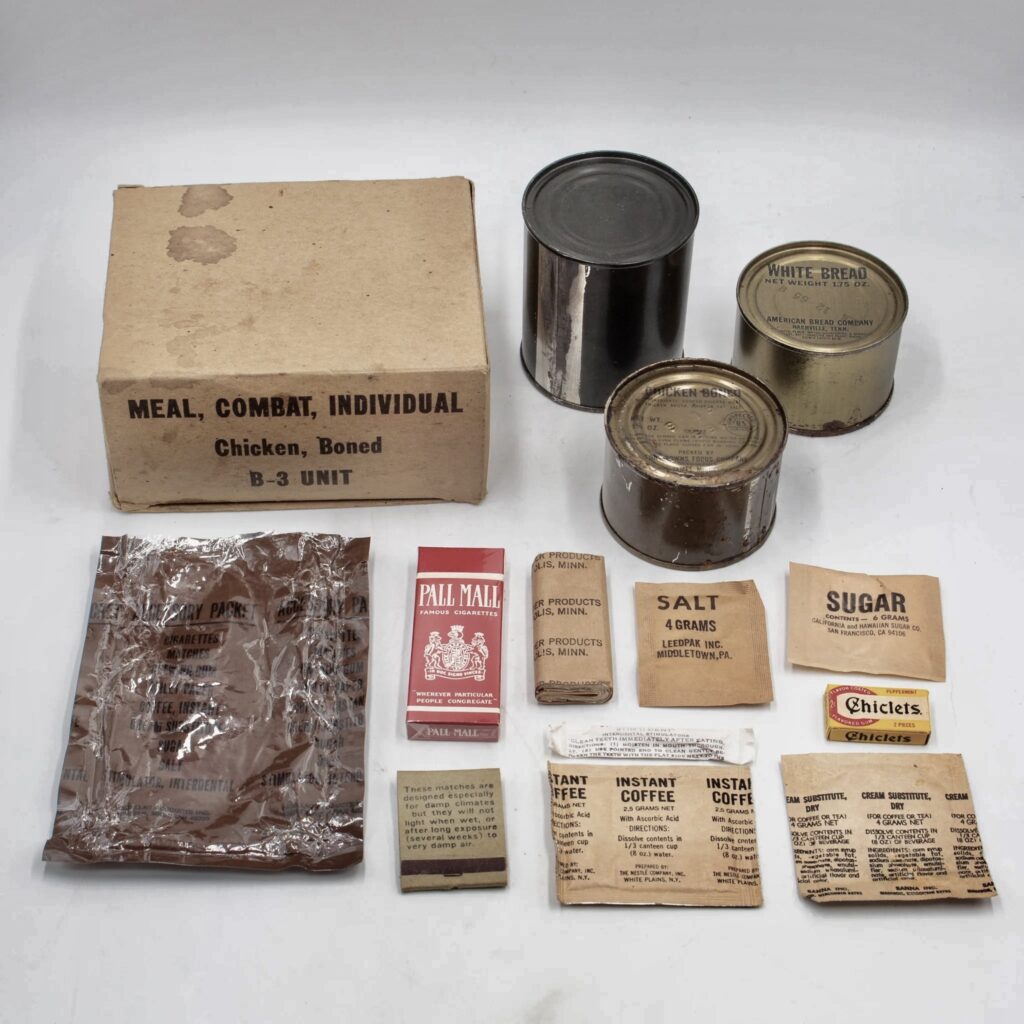 C-Ration opened up to show cans of food with packets of accessories, coffee, sugar, cigarettes and Chicklets gum.  Biography of Dr. Anthony J. Carbone.