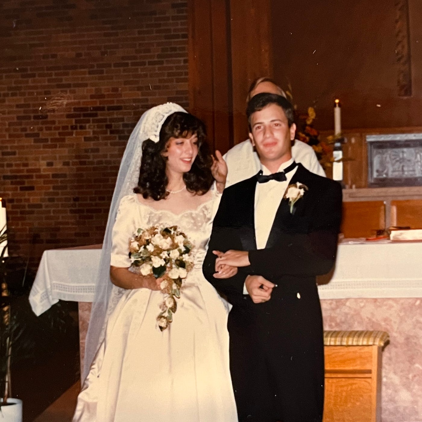 Priest presents the newly married couple.  Sacrament of Holy Matrimony between Mariann Schmitz and Anthony Carbone at St. Michael's Catholic Church in Wheaton, Illinois on October 30, 1982.