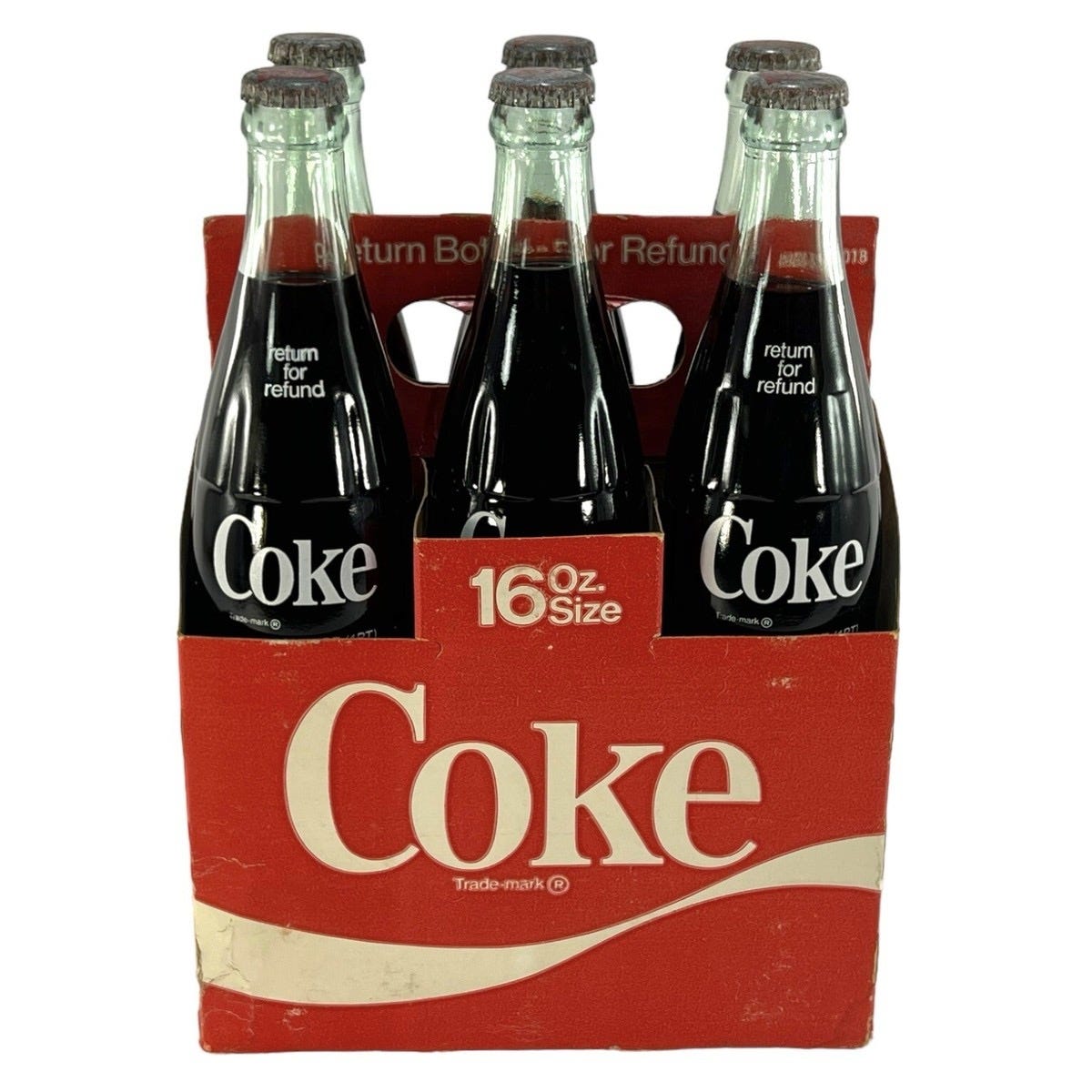 Vintage carton of 16 ounce Coca-Cola bottles circa 1970s. Biography of Dr. Anthony J. Carbone.