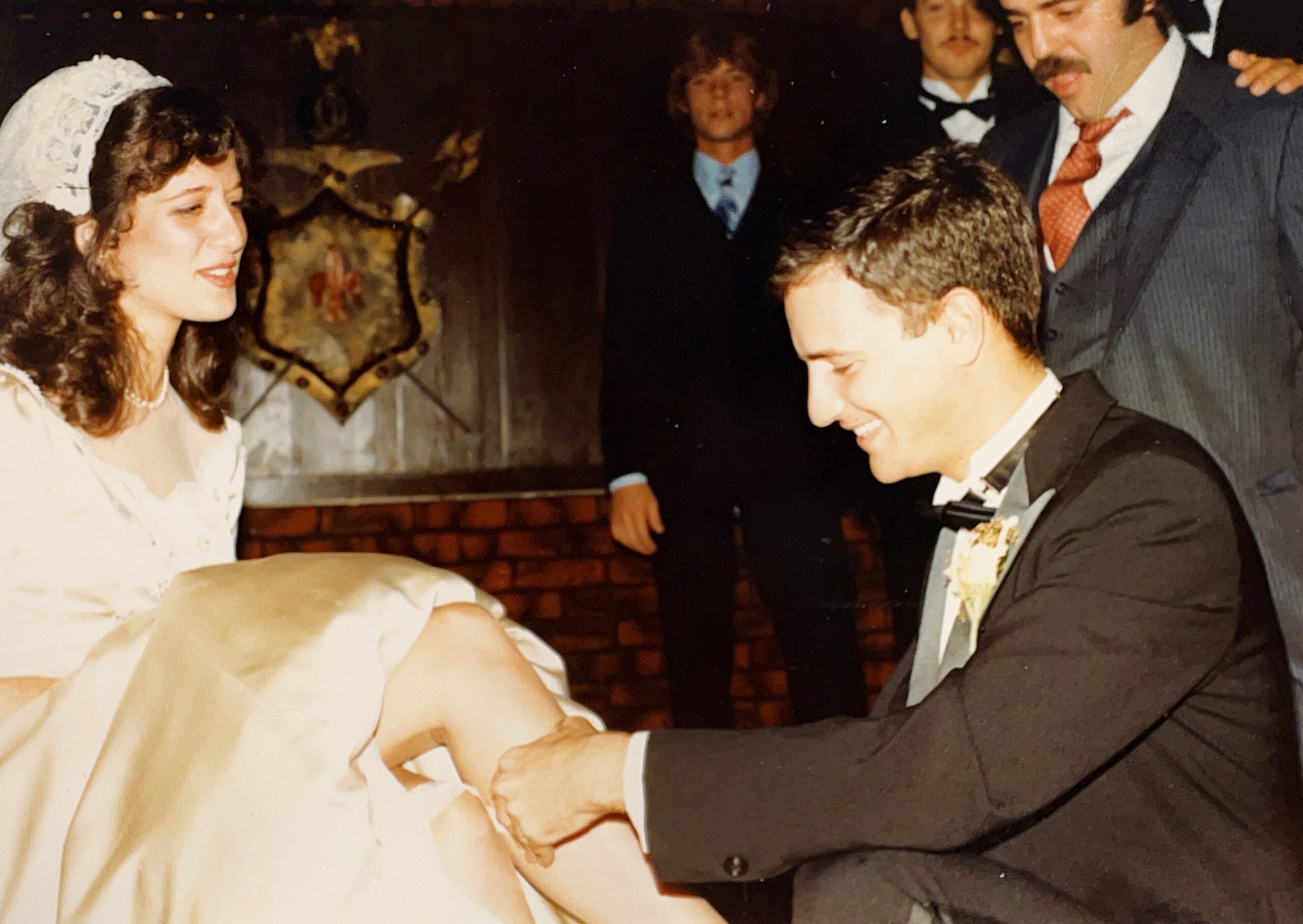 Anthony Carbone the groom removing his bride's (Mariann's) garter at the wedding reception on October 30, 1982.