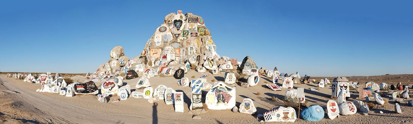 The iconic Painted Rocks Memorial on the route to Fort Irwin, California.  Biography of Dr. Anthony J. Carbone.