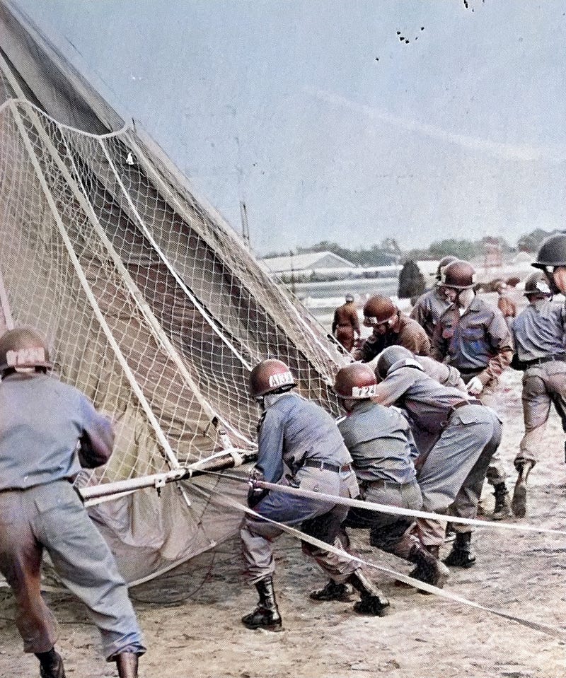 Rigging the chute for the 250-foot free drop tower at the U.S. Army Airborne Course at Fort Benning, Georgia.  Biography of Dr. Anthony J. Carbone.