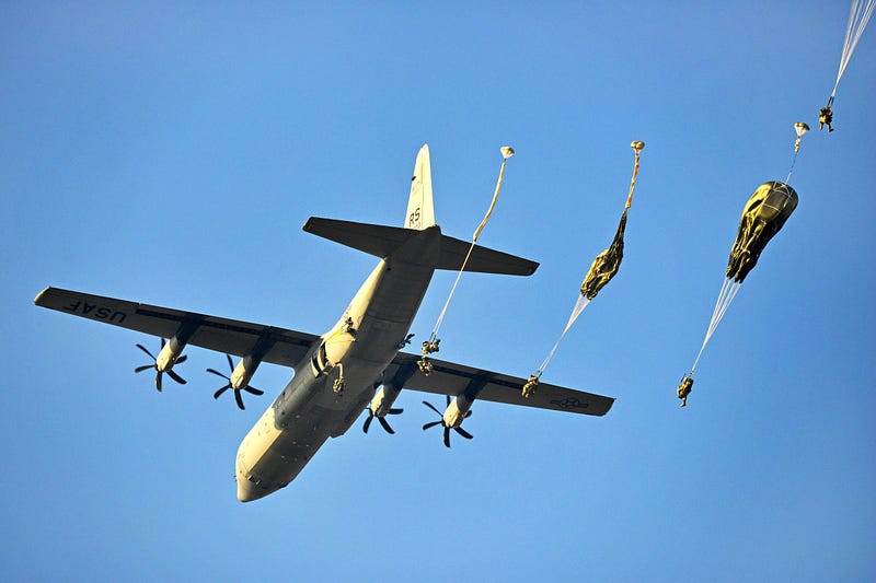 C-131 Hercules dropping paratroopers at the U.S. Army Airborne School at Fort Benning, Georgia.  Biography of Dr. Anthony J. Carbone.