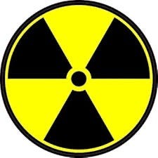 Radiology symbol with circle and 3 black triangles and 3 yellow triangels. Biography of Dr. Anthony J. Carbone.