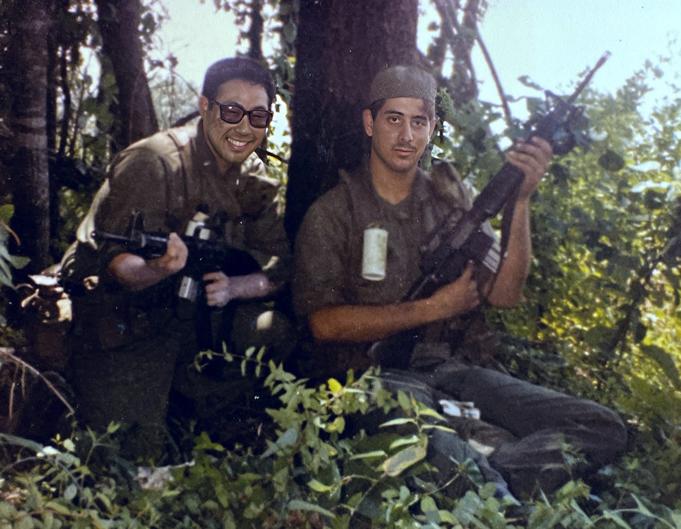 Photograph of two of my Chemical Officer Basic Course (COBC) lieutenants in fatigues and carrying M16 rifles in the forest. Biography of Dr. Anthony J. Carbone