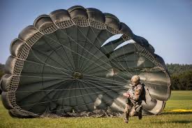 Final jump before graduation.  Rolling up parachute.  Biography of Dr. Anthony J. Carbone.