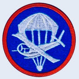 Airborne patch with parachute and glider that was worn on the old garrison cap.  Biography of Dr. Anthony J. Carbone