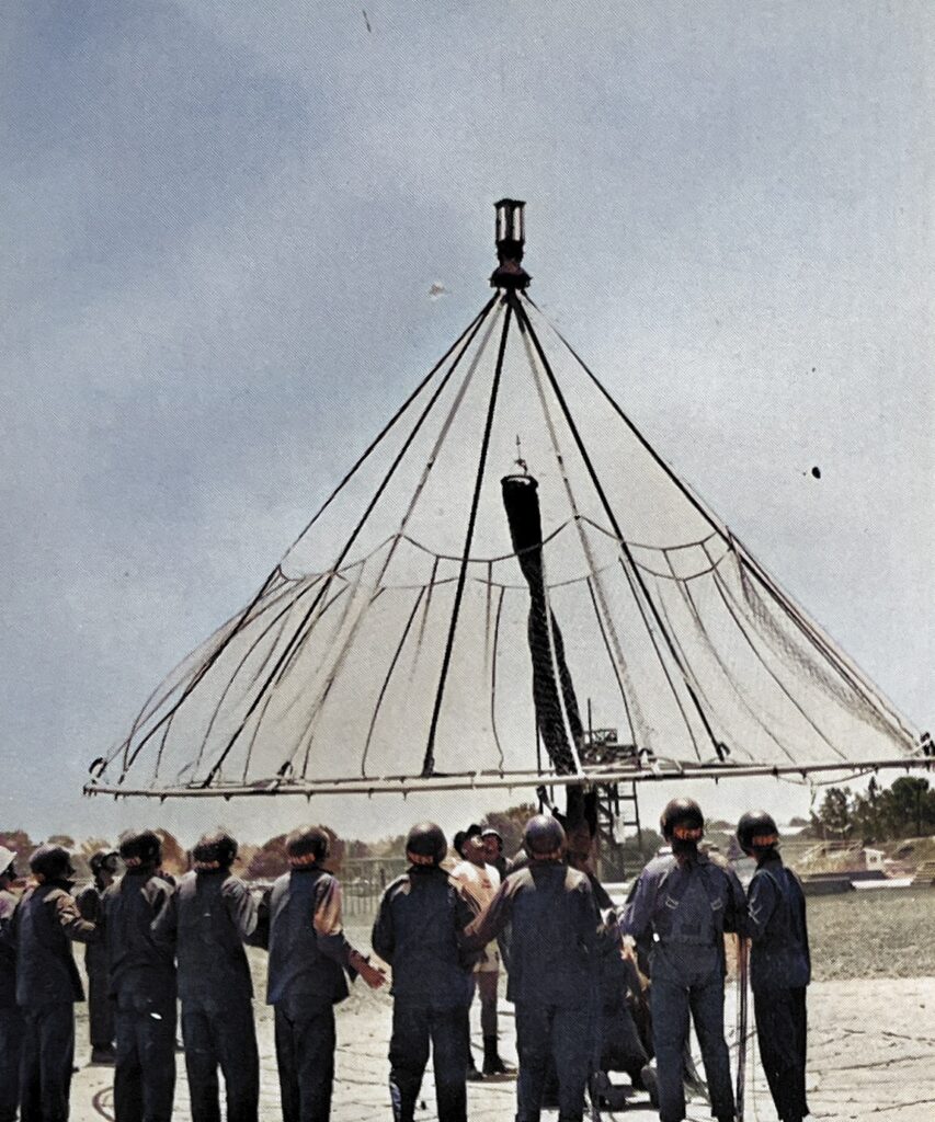 Rigging the chute for the 250-foot free drop tower at the U.S. Army Airborne Course at Fort Benning, Georgia.  Biography of Dr. Anthony J. Carbone.