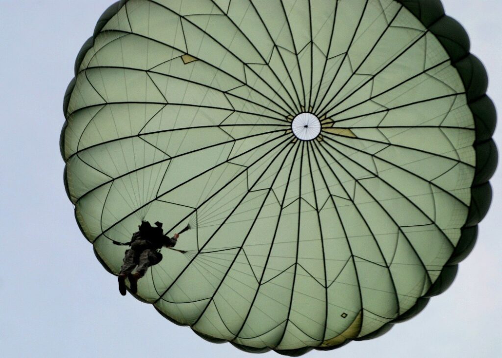 Final jump before graduation.  Single paratrooper under a T-10 parachute.  Biography of Dr. Anthony J. Carbone.