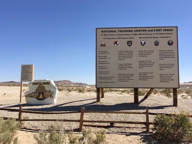 Fort Irwin Welcome Sign and painted rocks along Fort Irwin Road.  Biography of Dr. Anthony J. Carbone.