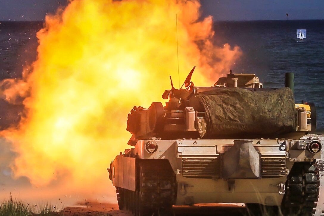M1 Abrams tanks firing at night at the Live Fire Range at the National Training Center at Fort Irwin, California.  Biography of Dr. Anthony J. Carbone.