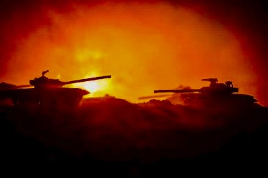 Main battle tanks illuminated at night by incendiary devices at the National Training Center at Fort Irwin, California.  Biography of Dr. Anthony J. Carbone.