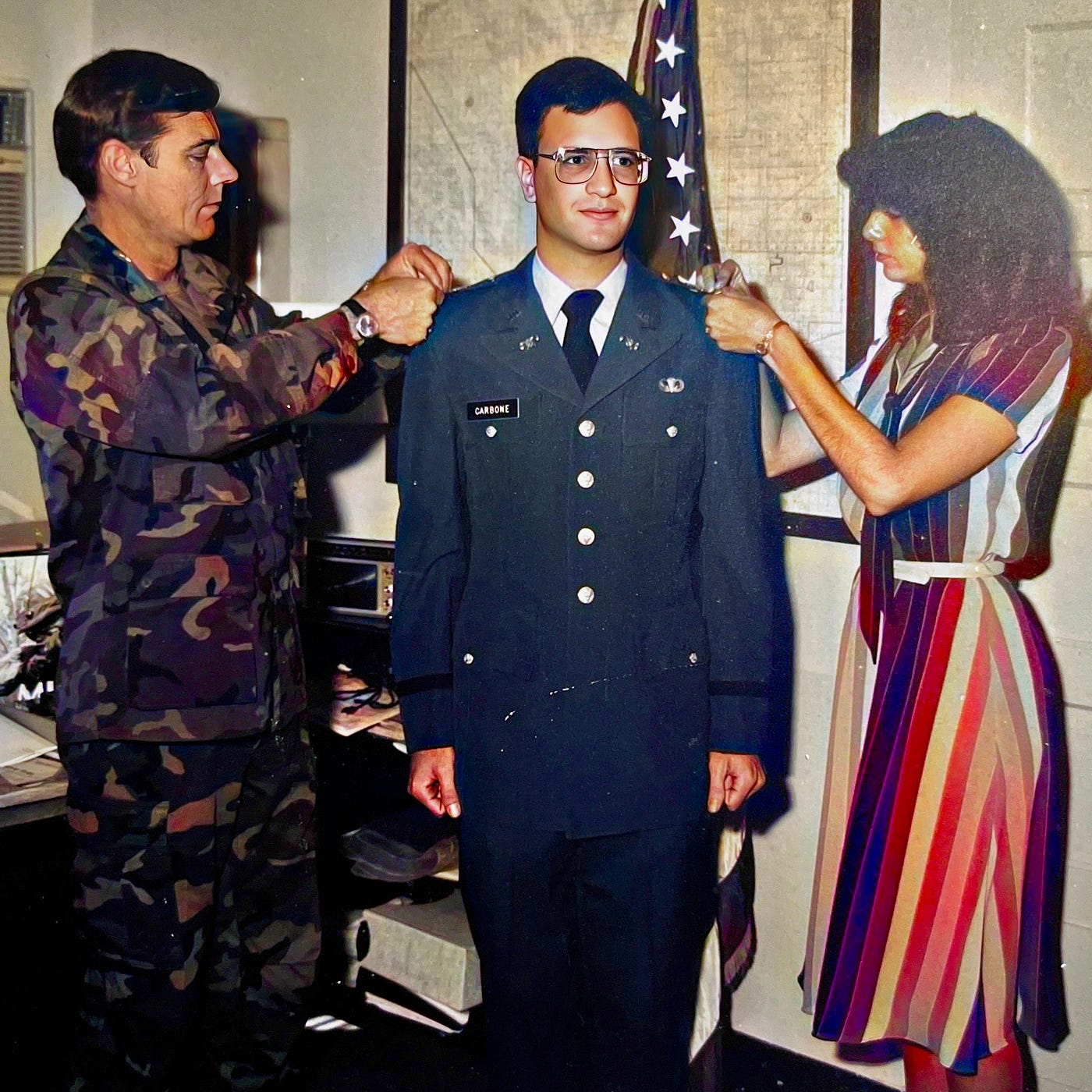2LT Anthony J. Carbone being promoted to First Lieutenant by his boss LTC Gary Roderick (Chief of DPTSEC) and wife Mariann Carbone pinning on new silver bar.