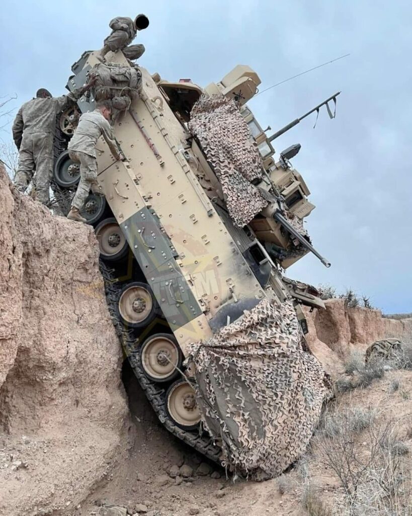 U.S. Bradley Fighting Vehicles in vertical, unmaneuverable positions at the National Training Center.  Biography of Dr. Anthony J. Carbone