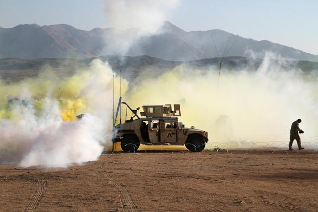 Members of the Chemical Smoke Platoon laying down smoke and obscurants during battles at the National Training Center at Fort Irwin, California.  Biography of Dr. Anthony J. Carbone.