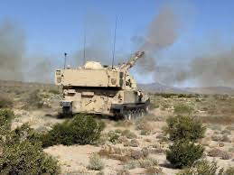 Self-propelled artillery battery firing live rounds at the life fire range at the National Training Center at Fort Irwin, California.  Biography of Dr. Anthony J. Carbone.