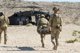 Helicopter MEDEVAC evacuation of wounded soldier at the National Training Center at Fort Irwin.  Biography of Dr. Anthony J. Carbone.