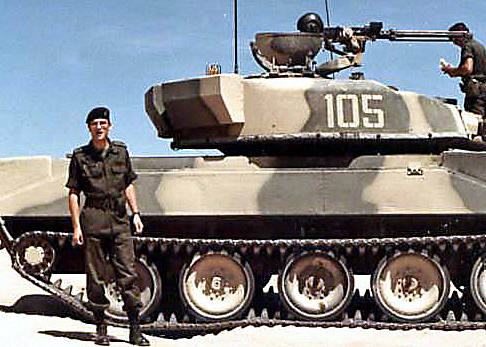 1LT Anthony Carbone in OPFOR uniform in front of a Soviet style T72 VISMOD at the National Training Center at Fort Irwin, California.